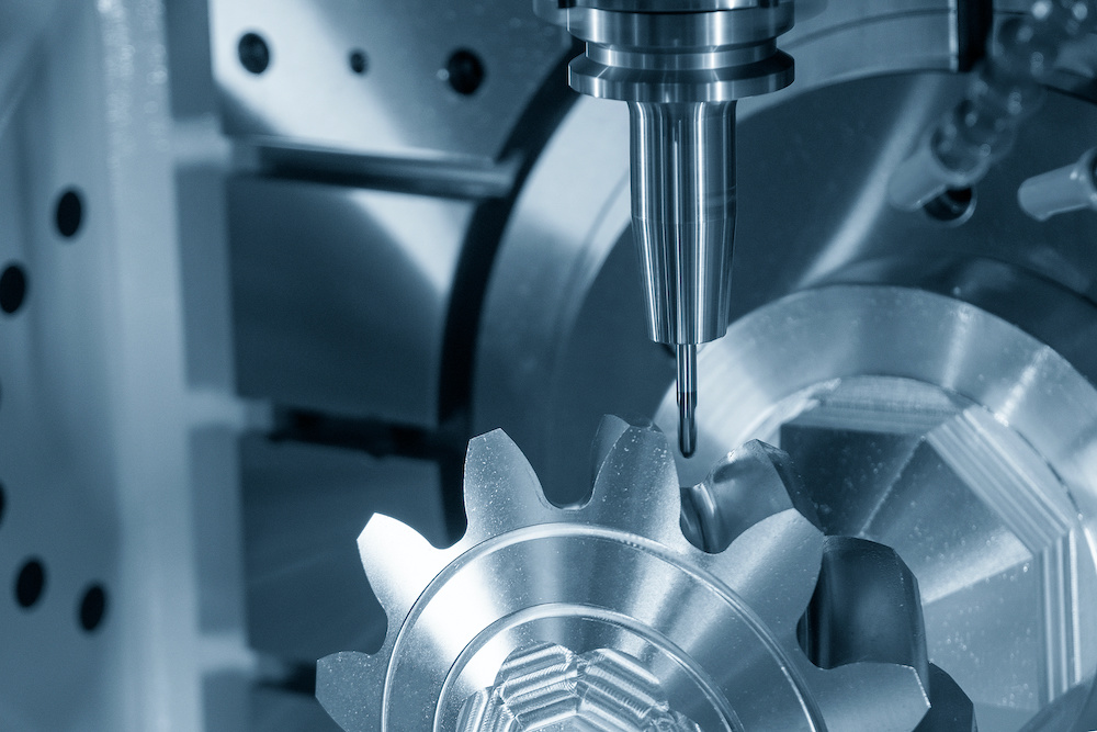 Close up scene the 5 axis CNC milling machine cutting the metal gear part.